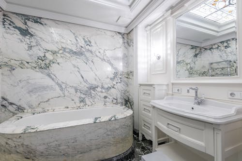 Marble Wall Bathroom with Bathtub and Sink