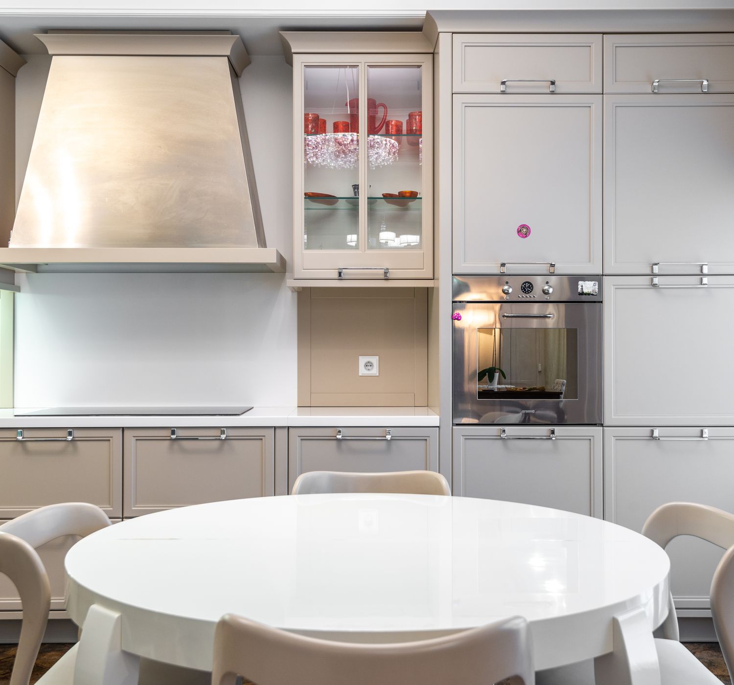 Contemporary kitchen with sleek cabinets and a round dining table.