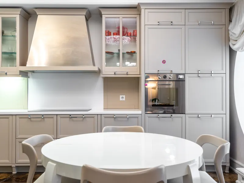 Contemporary kitchen with sleek cabinets and a round dining table Contemporary kitchen with sleek cabinets and a round dining table