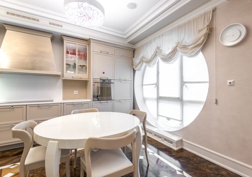 Free Luxurious kitchen interior with modern furniture and elegant lighting. Bright and spacious dining area. Stock Photo