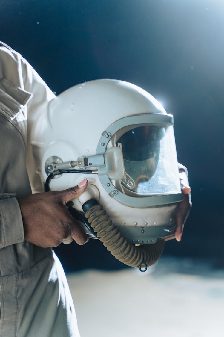 A Person Holding A Helmet