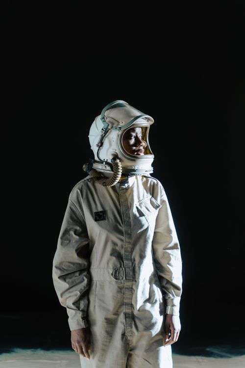 Free Dramatic portrait of a person in a spacesuit against a dark background. Stock Photo