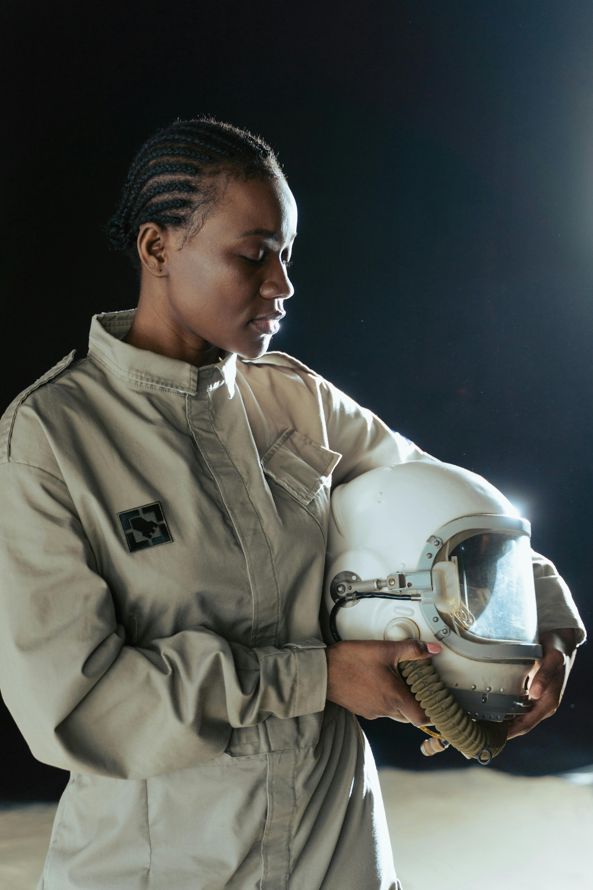 a female astronaut holding a helmet