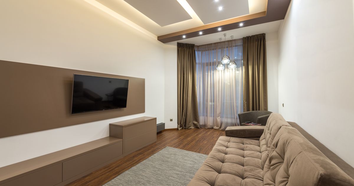 A cozy living room with a television and a couch.