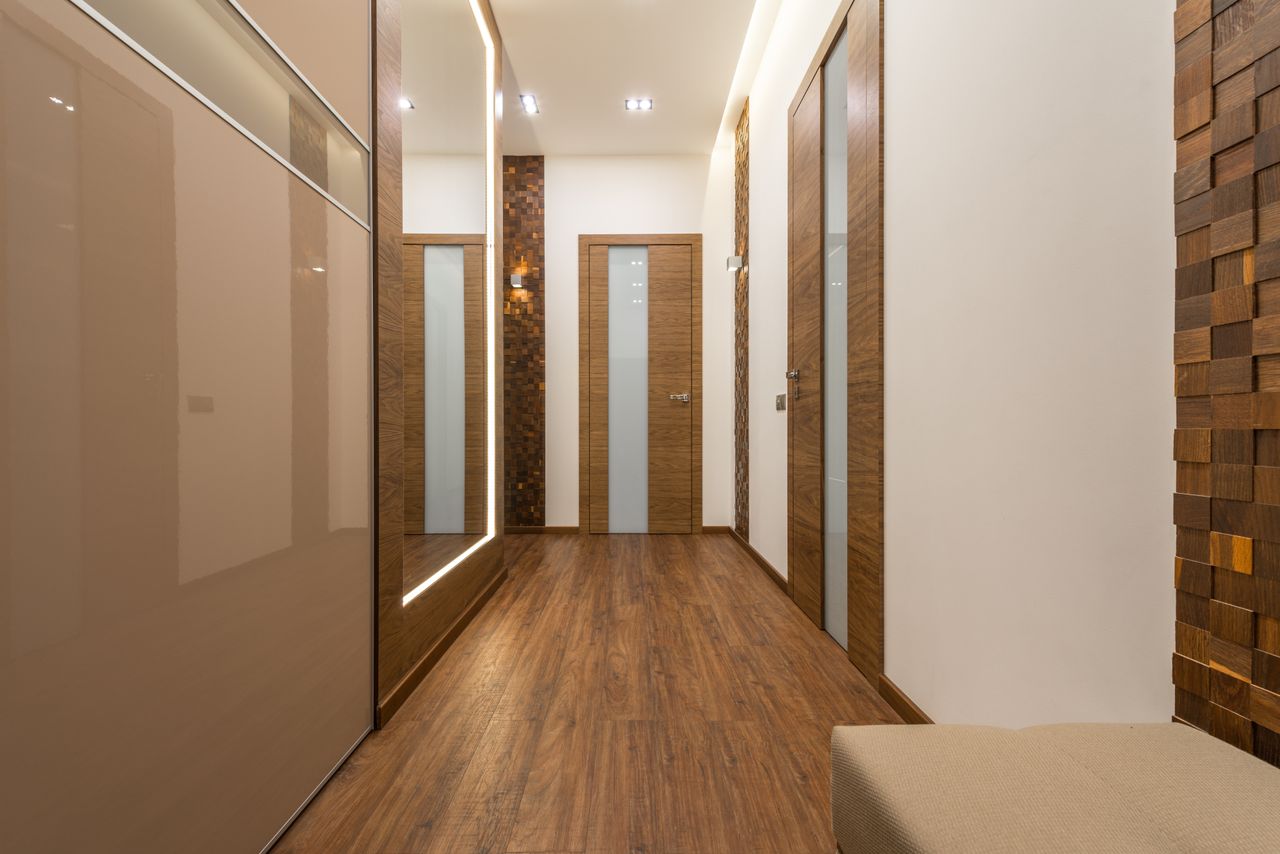 Luxurious hallway with wooden interior doors with frosted glass strips