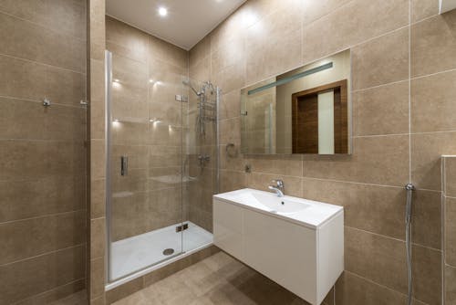 A Shower Room with Glass Door Near the Lavatory