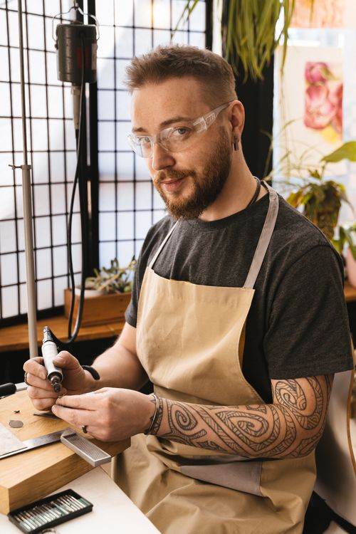 Free Male craftsman in workshop using tools for woodworking projects. Stock Photo