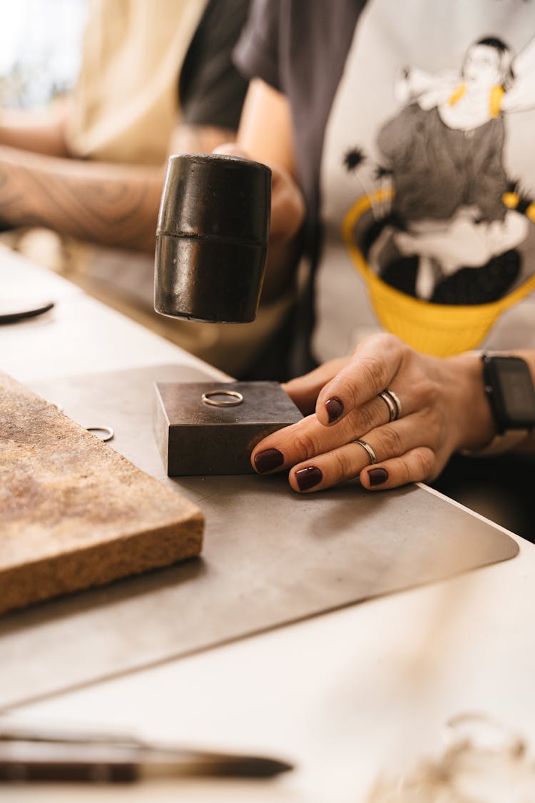 Woman Hammering A Ring