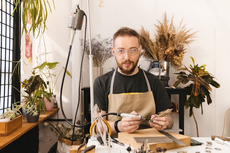 Man Polishing Piece Of Jewell