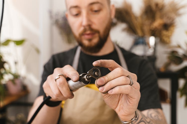 Man Polishing Metal Piece