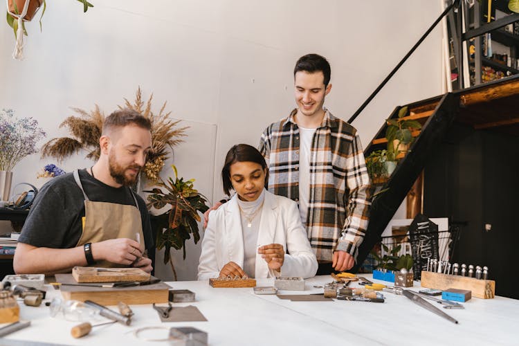 Men And Woman Tinkering Together