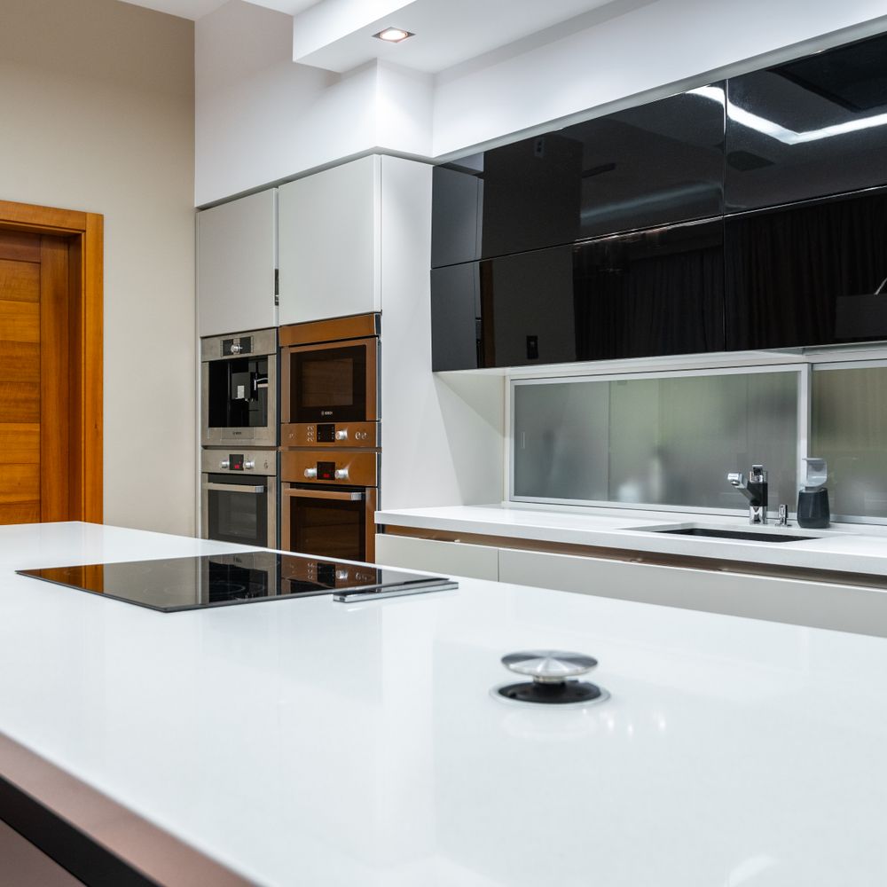 Kitchen Spraying in Colney Hatch — a decorator at work mid-project