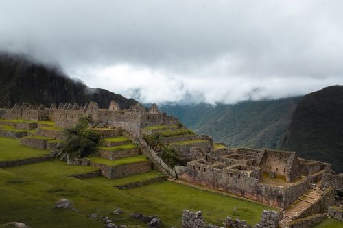 Free Breathtaking view of Machu Picchu in Peru with misty clouds over ancient Incan ruins. Stock Photo