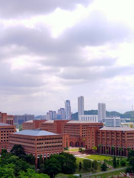 Skyline featuring modern skyscrapers and classic brick architecture under cloudy skies.