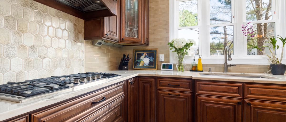 Kitchen backsplash tile being repaired above a counter in a Rockville home