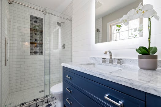 A stylish bathroom interior with marble countertop and glass shower.