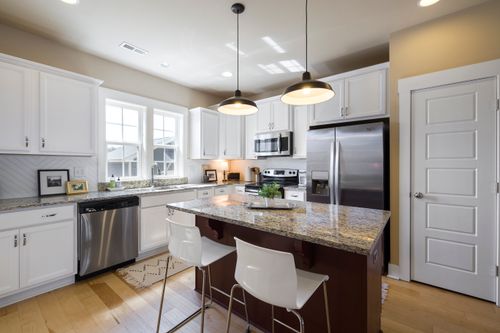 Free Sleek and modern kitchen design featuring a center island and stainless steel appliances. Stock Photo