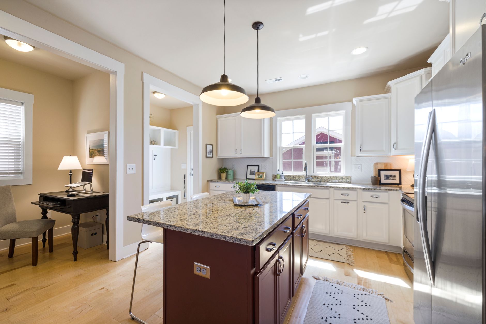 Bright open-plan living room staged for sale with neutral furniture and natural light