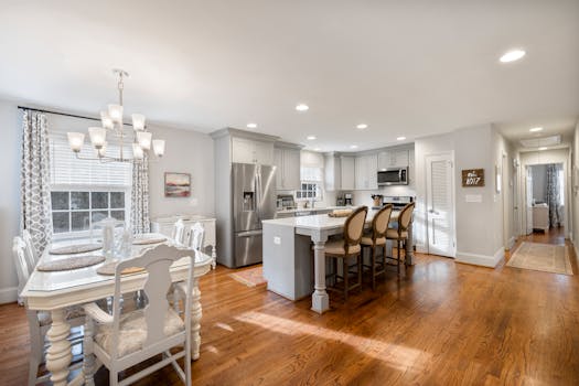 Spacious and elegant dining room with a connected modern kitchen in a minimalist style.