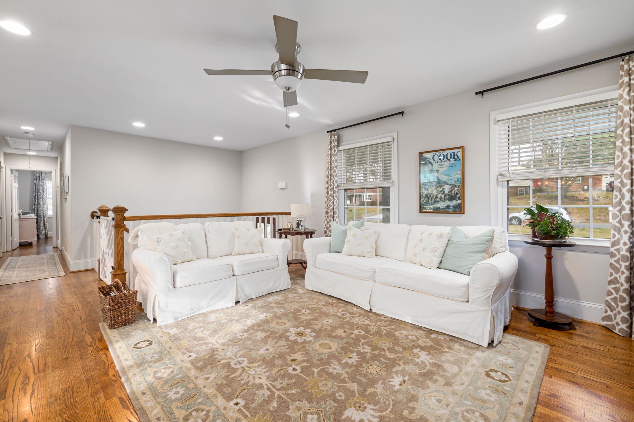 Bright furnished living room with warm wooden flooring