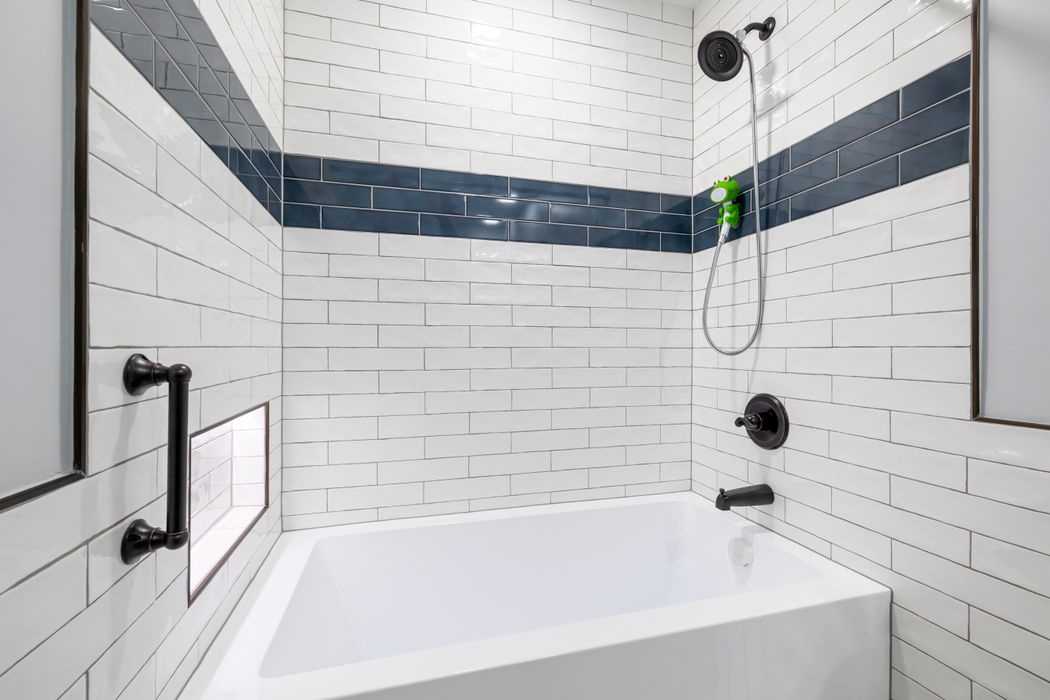 Modern blue-tiled bathroom with safety features