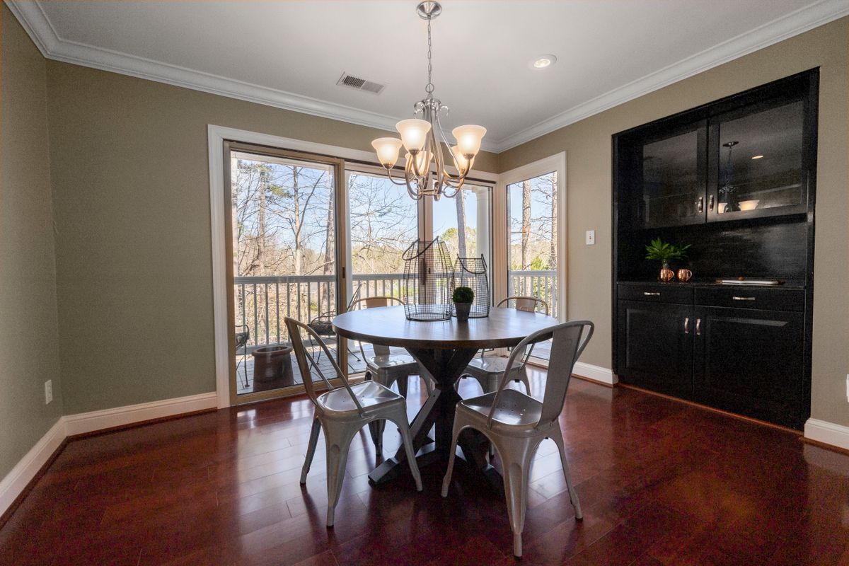 Dining room with round table and chandelier lighting