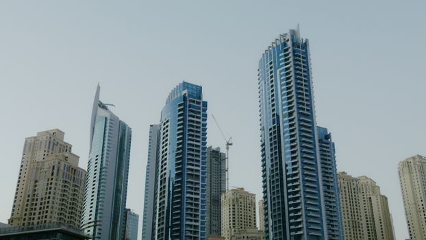 Dramatic capture of modern skyscrapers against a clear sky.