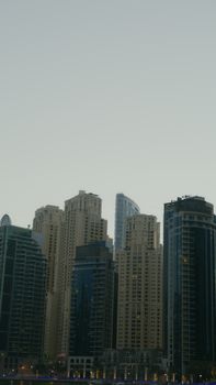 A bustling urban skyline featuring high-rise buildings at twilight.