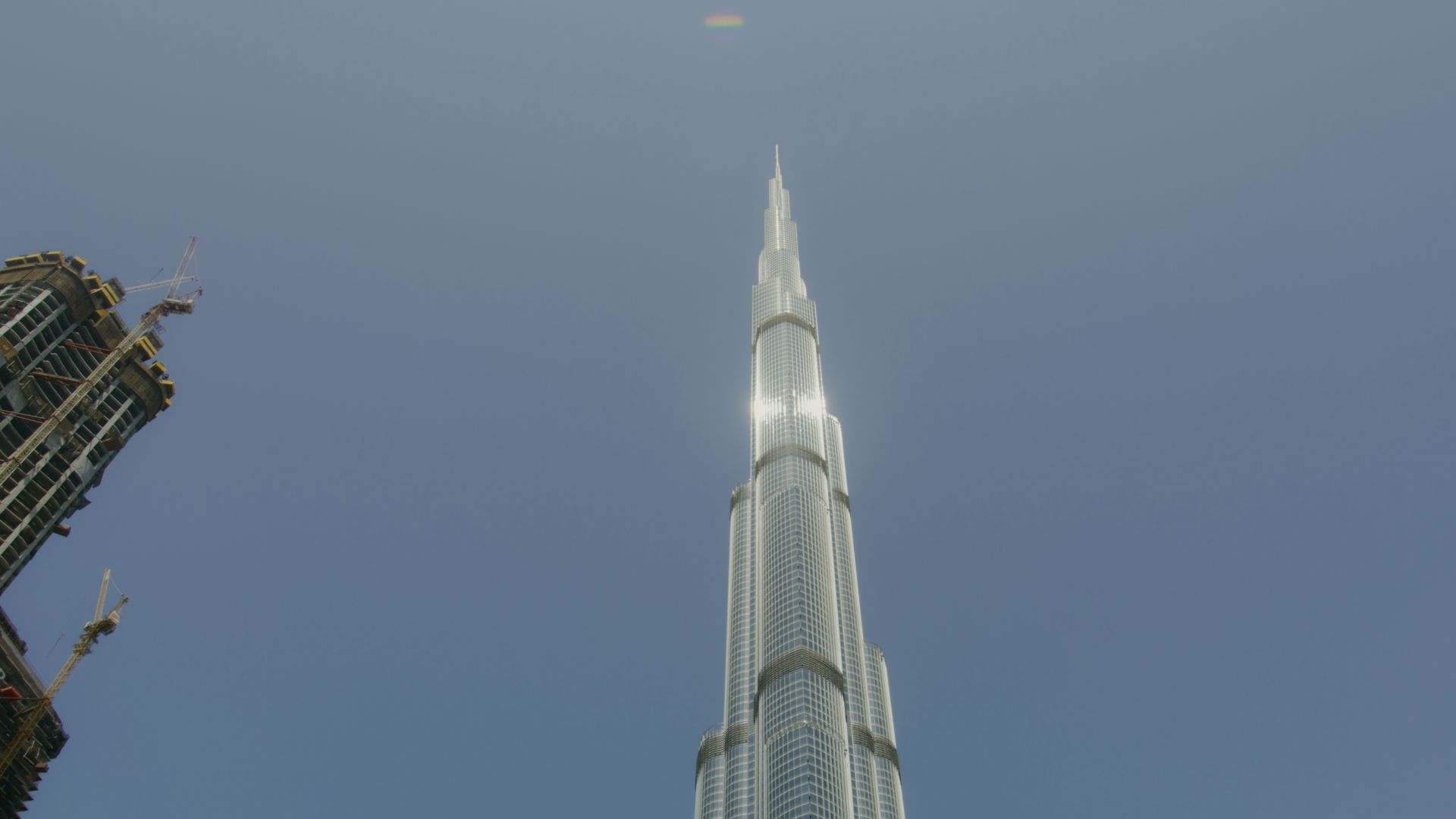 Low angle shot of the iconic Burj Khalifa towering against a clear blue sky in Dubai.
