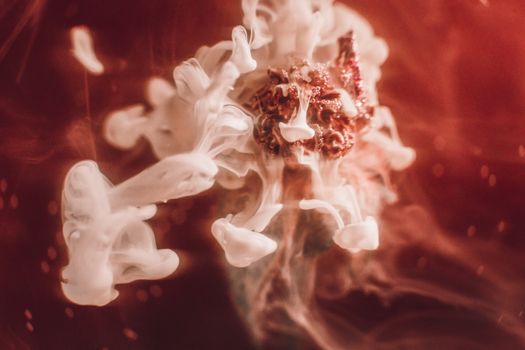 Ethereal abstract art featuring swirling white and red hues in a fluid motion, captured with selective focus.