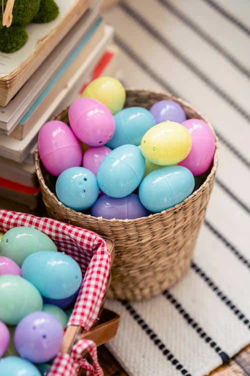 Free High angle of colorful painted eggs in basket and bucket on carpet during Easter holiday in house Stock Photo