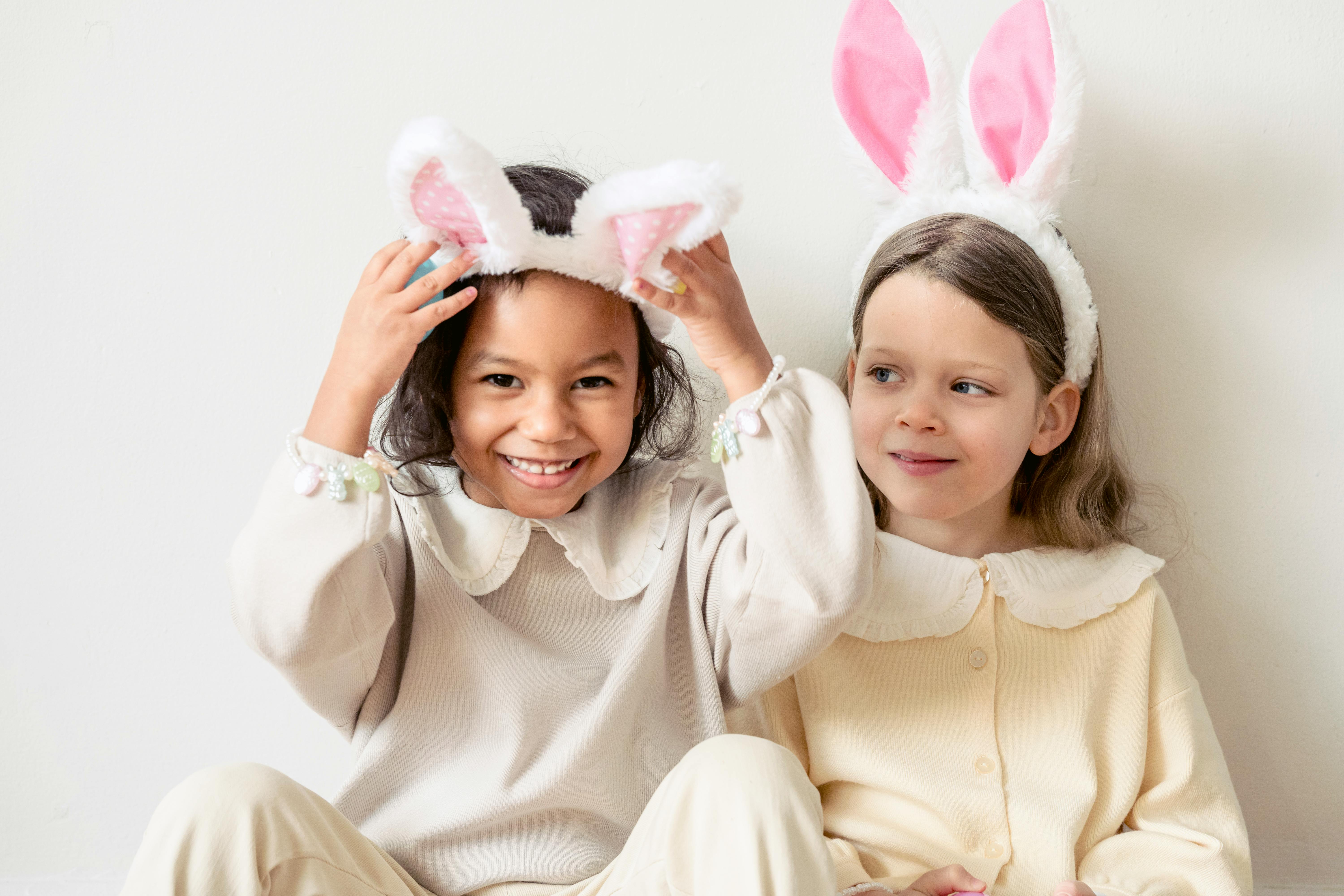 happy diverse girls wearing bunny ears in kindergarten