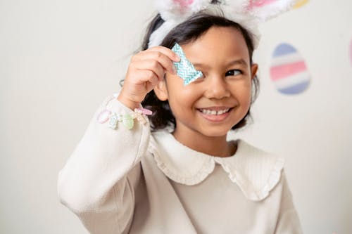 Delighted child showing candy during Easter holiday