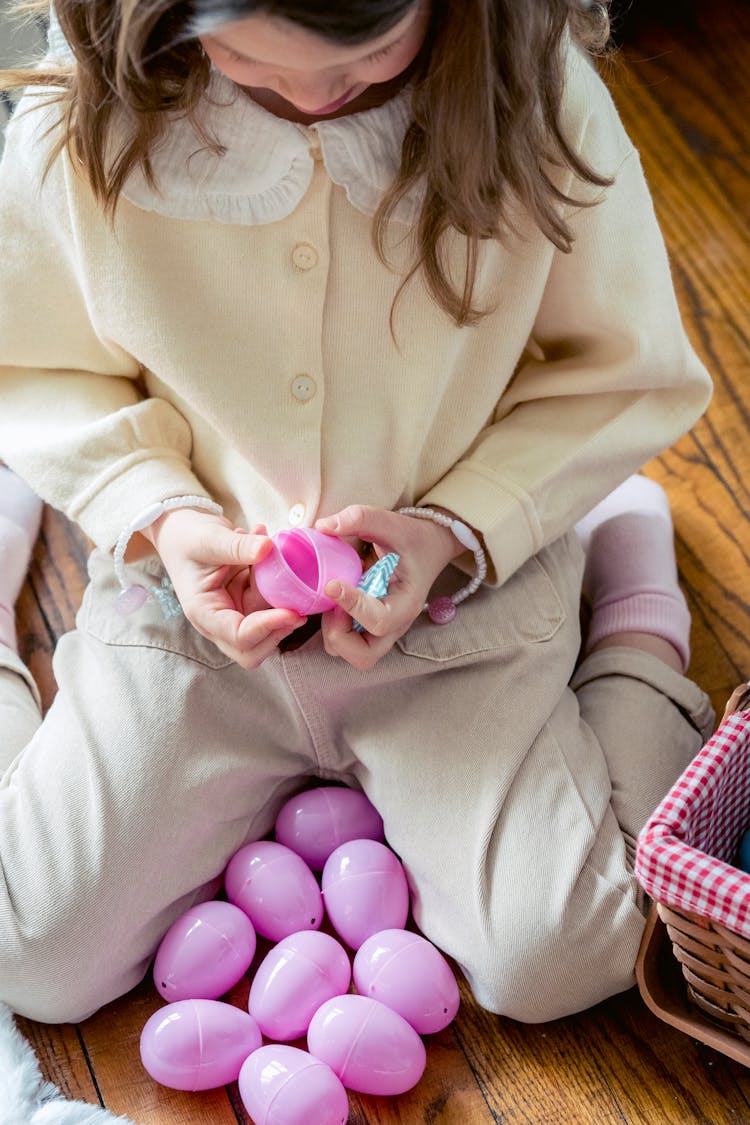 Adorable Kid Opening Toy Egg On Floor