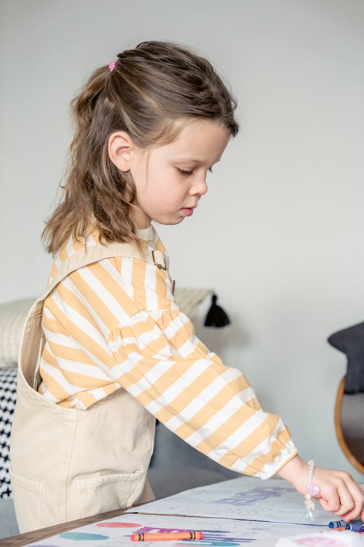 Serious Girl Taking Crayon For Drawing Picture