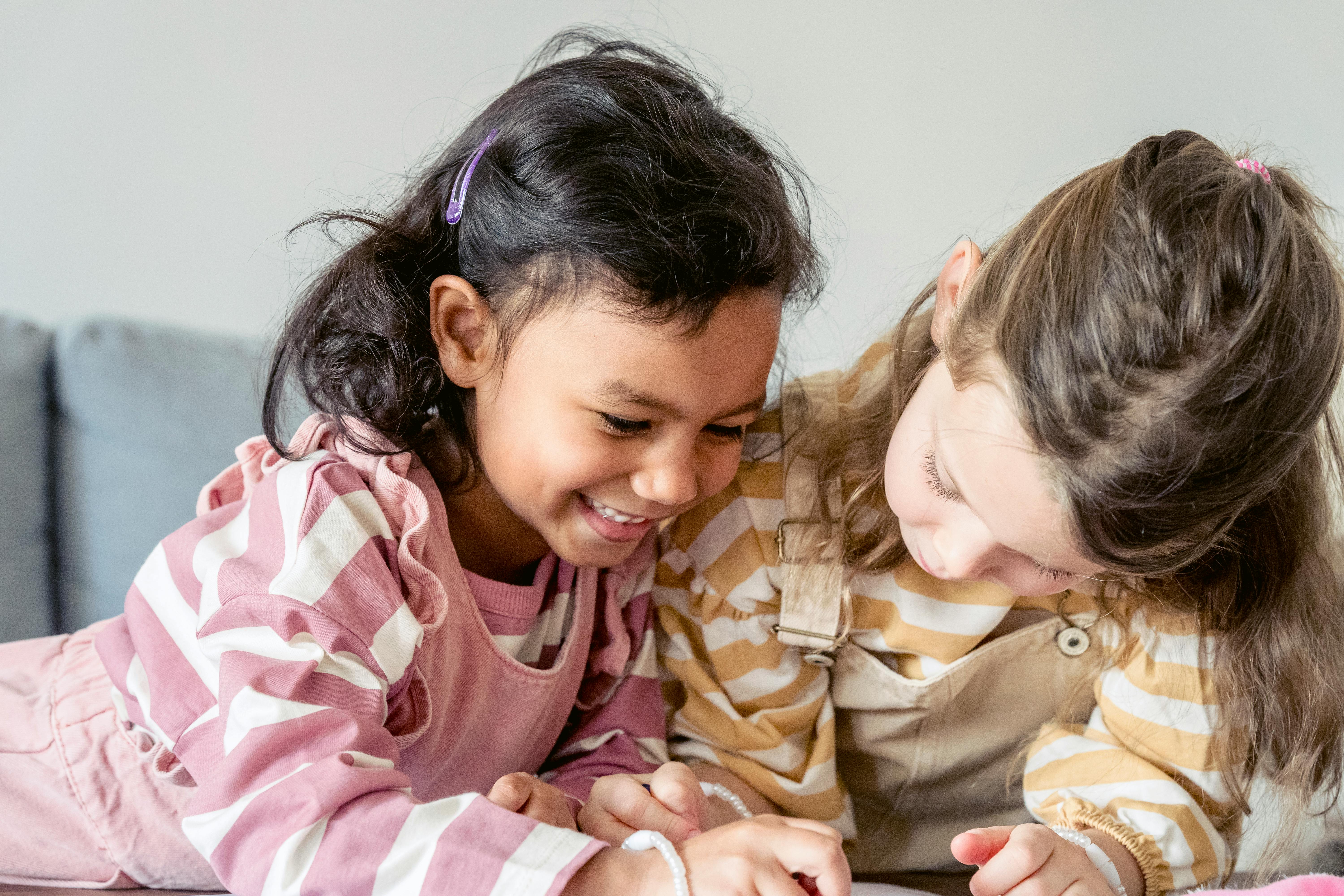 cheerful diverse girls drawing picture together