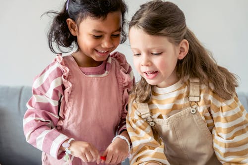 Cheerful diverse girls playing together