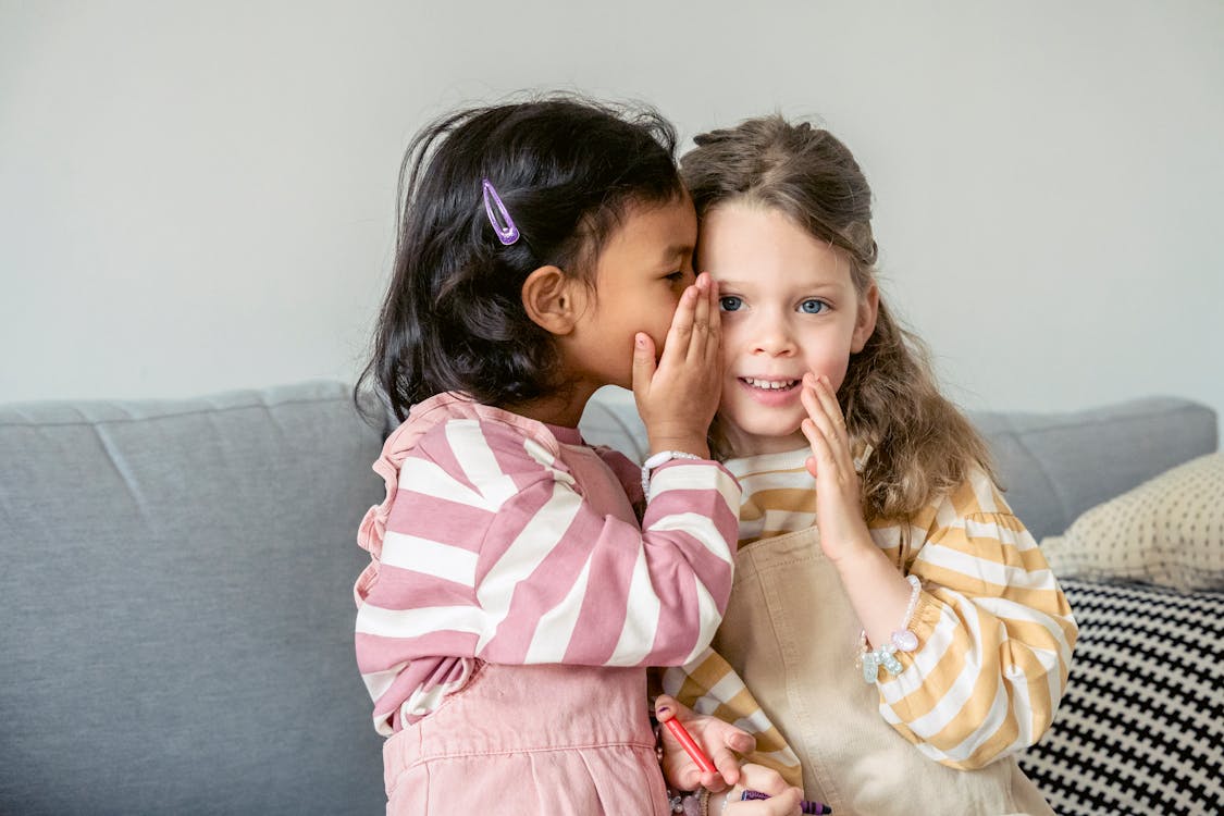 Two friends playing the whispering game