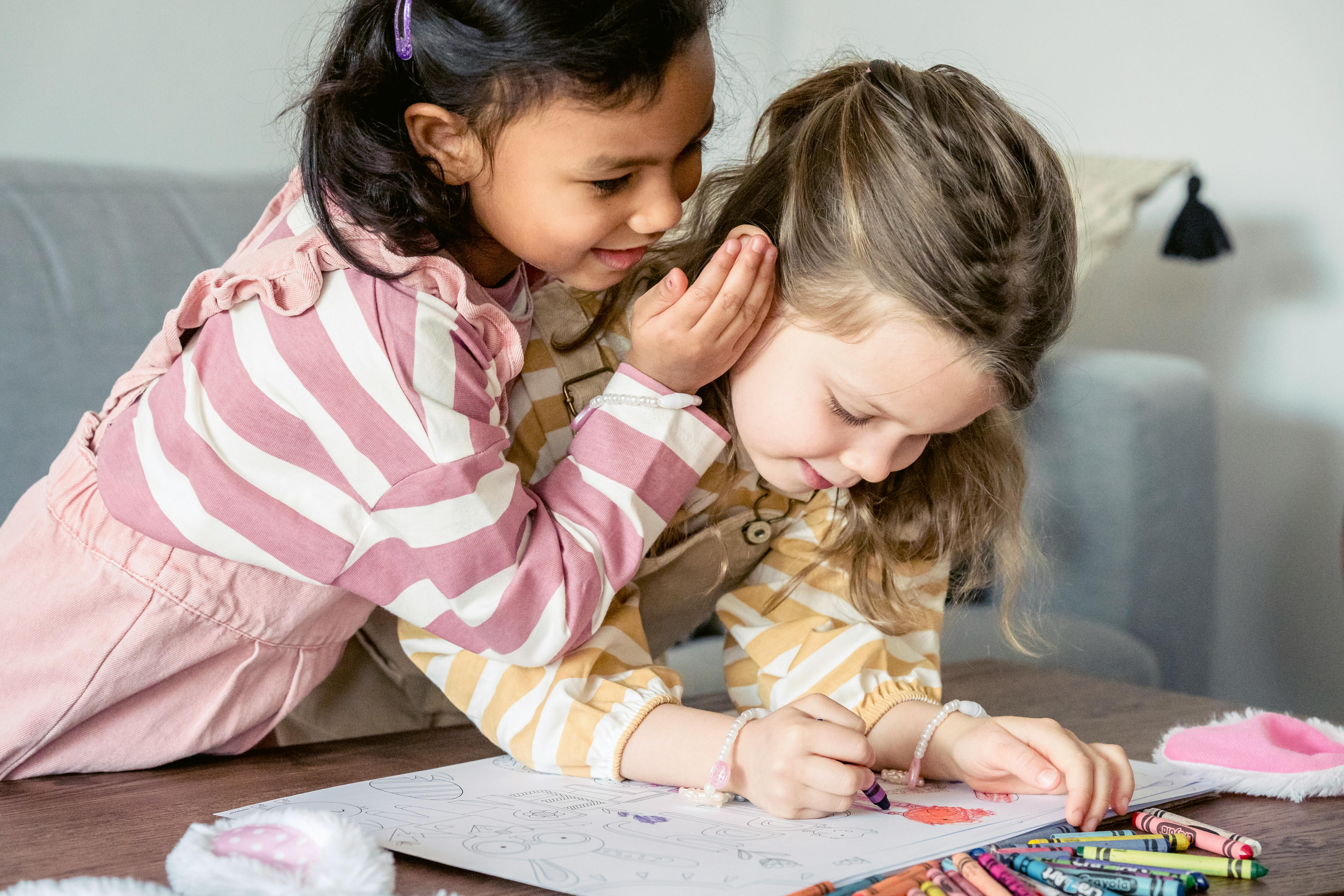 smiling ethnic girl telling secret to best friend