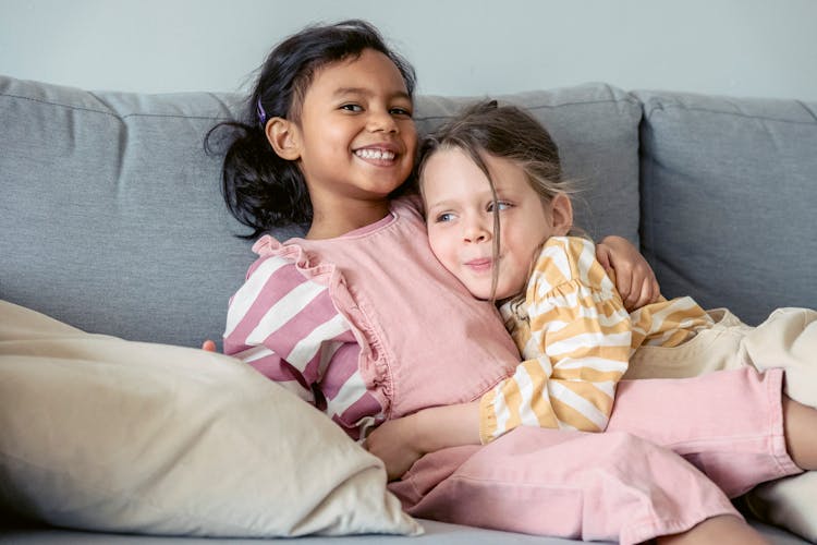 Cheerful Ethnic Girl Embracing Best Friend