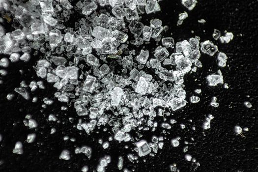Macro shot showcasing crystal ice cubes against a dark textured background.