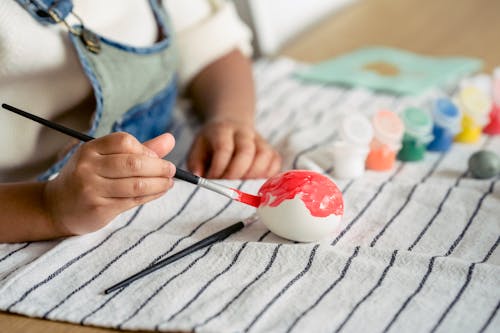 Close-up of Child Painting Easter Egg