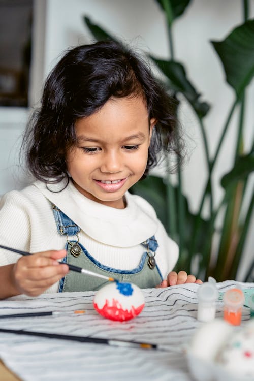 Portrait of a Girl Painting Easter Eggs