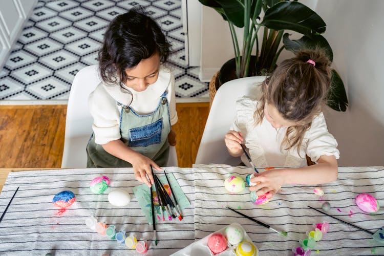 Focused Diverse Girls Painting Eggs