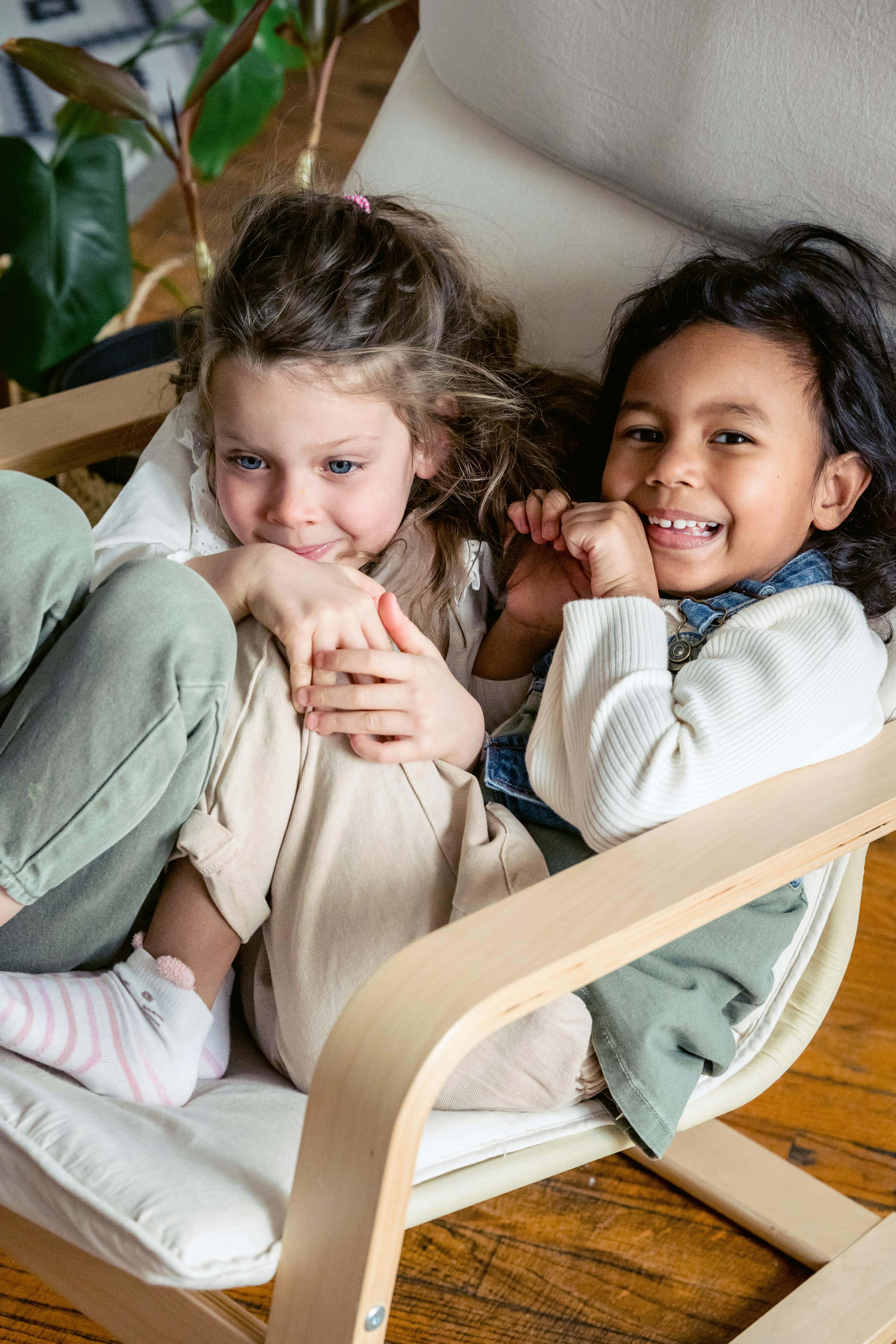 happy diverse girls having fun in armchair