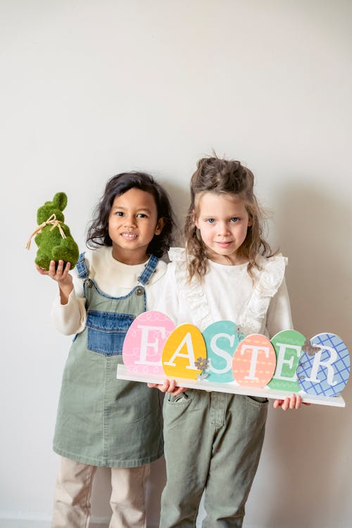 Positive diverse girls with Easter decorations