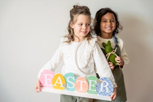 Happy multiracial girls with Easter decorations in room