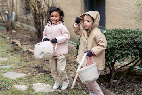Free Happy multiracial girls playing in backyard during Easter holiday Stock Photo