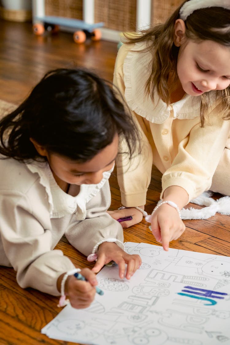 Crop Diverse Girls Coloring Drawing On Easter Day In House