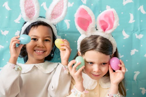 Content diverse girls with plastic eggs on Easter Day